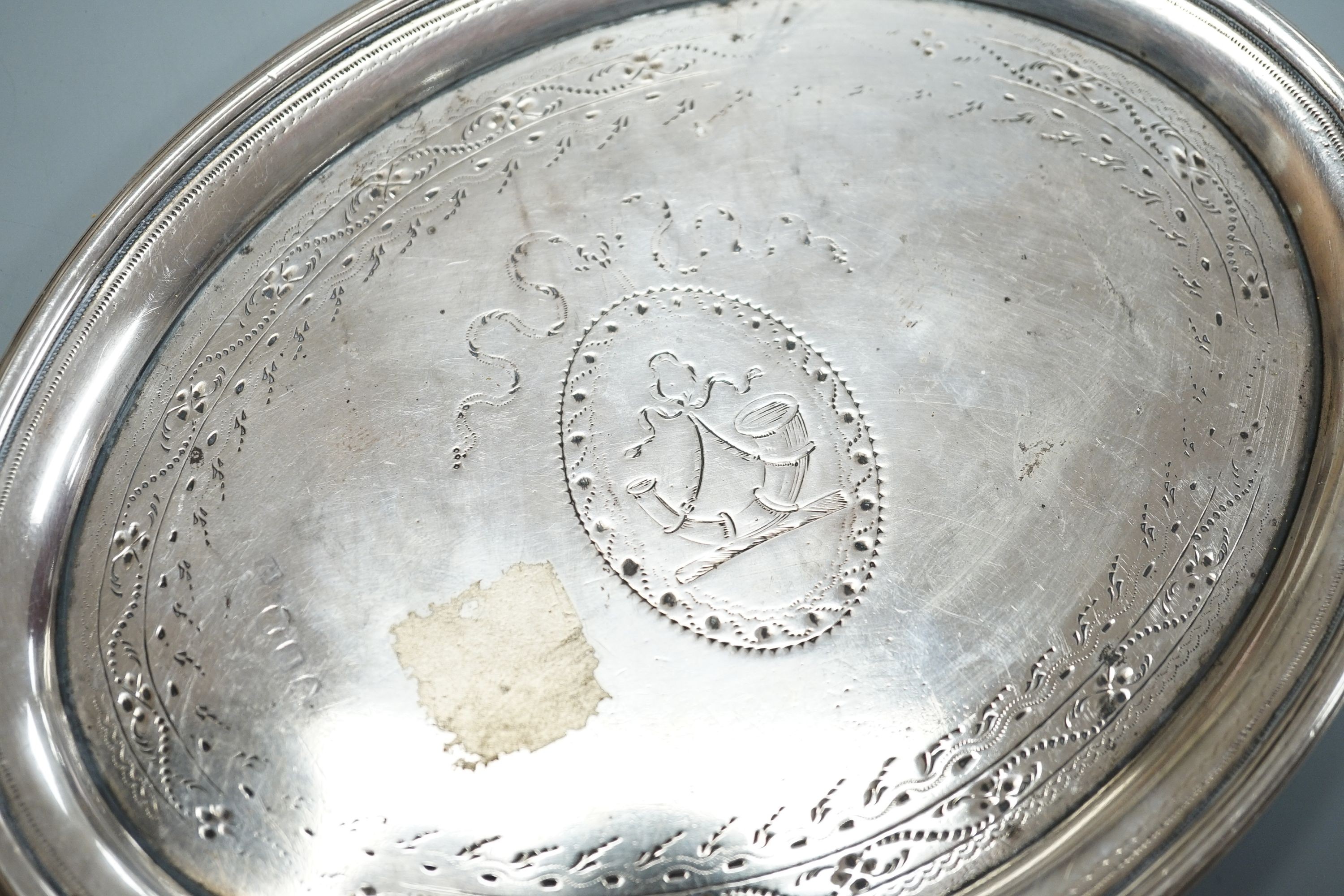 A George III silver oval teapot stand, with tired engraved decoration and wooden base, London, 1790, marks quite rubbed, 16.9cm.